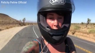 felicity feline riding on aprilia tuono motorcycle