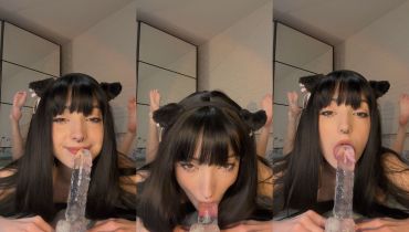 Cat-Eared Solo Babe Stares Deep Into Camera While Sucking On A Clear Toy